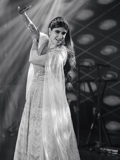 A timeless black and white shot of a bride's graceful solo performance. We focus on choreography that highlights elegance and poise.