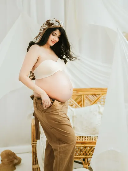A quiet, downward glance at the belly. This pose is perfect for capturing the introspective and deeply personal connection a mother feels with her unborn child.