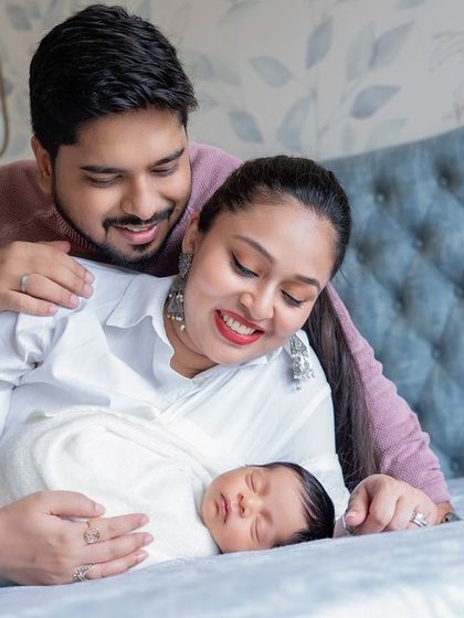 A cozy family portrait on the bed with their newborn. These lifestyle shots are relaxed and full of natural emotion.