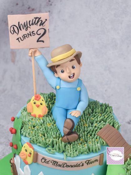 The 3D farmer figurine holding a sign for the birthday boy.