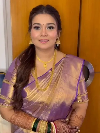 A beautiful guest draped in a lilac and gold Kanjeevaram saree, looking elegant and ready for a wedding.