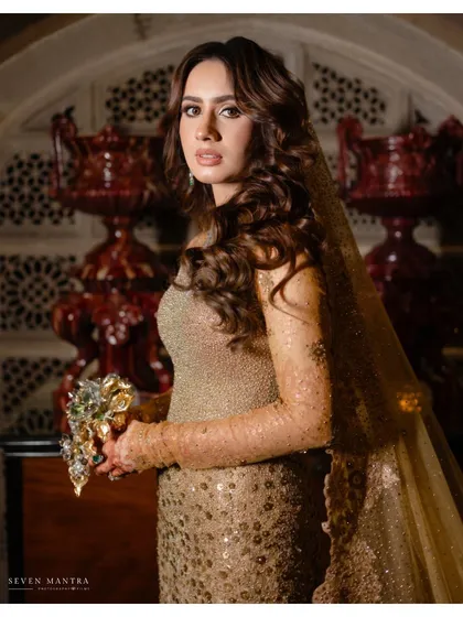 A close-up on classic beauty. This portrait highlights the intricate details of the bride's gown and her soft, glamorous hair and makeup, a look we curated together to fit the royal theme of her wedding.