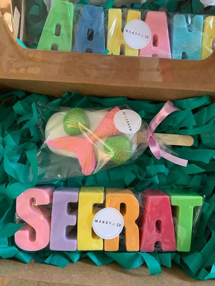 A beautiful mermaid-themed gift box featuring pastel rainbow name soaps for 'Arhaan' and 'Seerat'. Paired with a detailed mermaid popsicle soap, it's a magical and personal present.