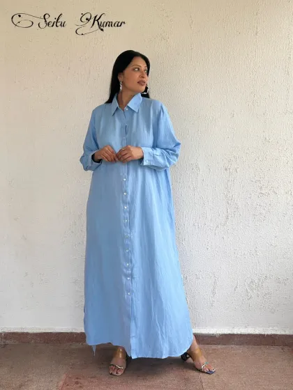 Another design from my label, this long, sky-blue shirt dress is crafted from a breathable linen blend. Its clean lines and simple elegance make it a perfect canvas for your favorite accessories.
