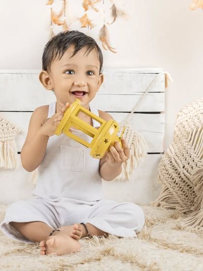 This little boy is having fun with a yellow lantern in our simple and clean lifestyle set.