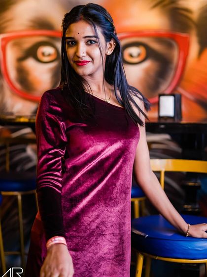 A guest in a velvet dress posing at the bar.