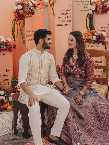 The couple sharing a sweet moment at their unique photobooth, a perfect backdrop for their pre-wedding photos.