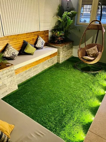 Even a small balcony can become a cozy retreat. We used high-quality artificial turf for a zero-maintenance lawn, paired with custom-built L-shaped seating and a hanging swing chair to maximize comfort and create a perfect spot for relaxation.