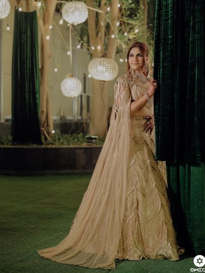 My client looking radiant in the champagne gold lehenga, a perfect blend of tradition and timeless luxury.