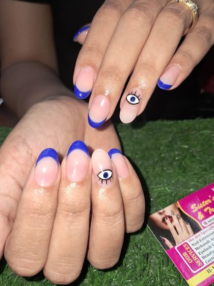 Another example of the blue French tip with an evil eye design, showing its versatility.