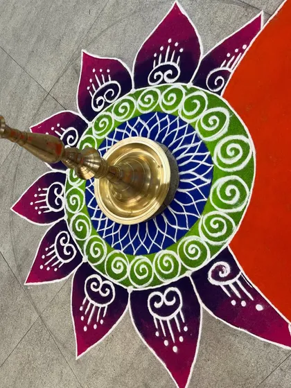 This mandala-style rangoli was designed to accommodate a traditional brass 'samai' lamp at its center. It's a great way to combine floor art with other decorative elements in an office space.