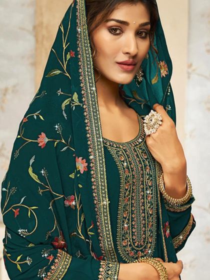 A beautiful teal salwar kameez with a heavily embroidered dupatta. The rich color and detailed thread work make it a sophisticated choice for any occasion.