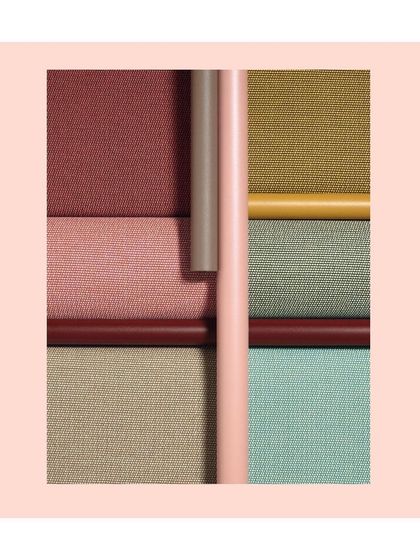 A mood board of fabric textures and colors, featuring shades of pink, green, and ochre. This is where a collection begins, with the interplay of different materials inspiring new designs.