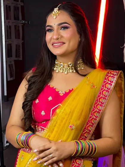 This vibrant multi-color lehenga in shades of yellow, pink, and green is perfect for a Mehendi or Haldi function.