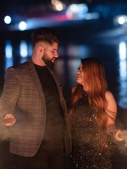 A close-up of the couple with fire props, capturing their intense connection and the dramatic lighting of the scene.