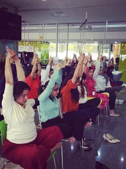 A moment of mindful stretching, reaching upwards to lengthen the spine and open the chest. This is a great way to counteract the posture of hunching over a computer.