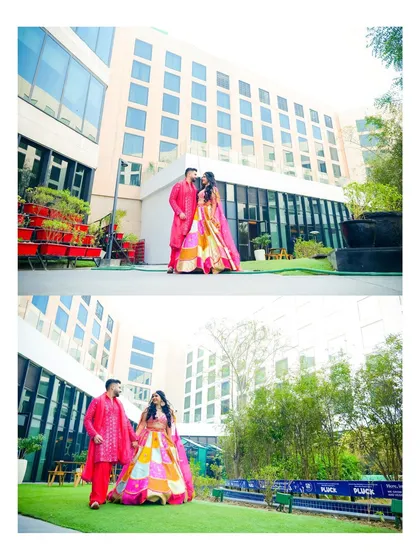 A wide shot showcasing the couple at their outdoor Mehendi event. The modern venue and lush greenery provide a beautiful contrast to their vibrant traditional attire.
