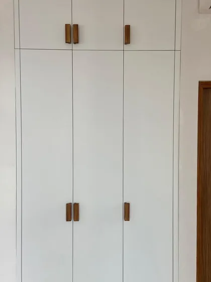 A full view of our Scandinavian-inspired wardrobe. The matte white acrylic shutters create a clean, bright look, perfectly complemented by the custom wood handles.