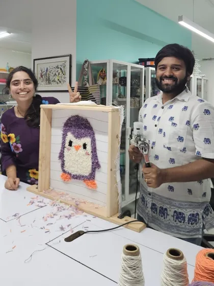 Here's a behind-the-scenes look at a family tufting session. They are working together to create this adorable purple penguin, sharing laughs and creative ideas along the way.