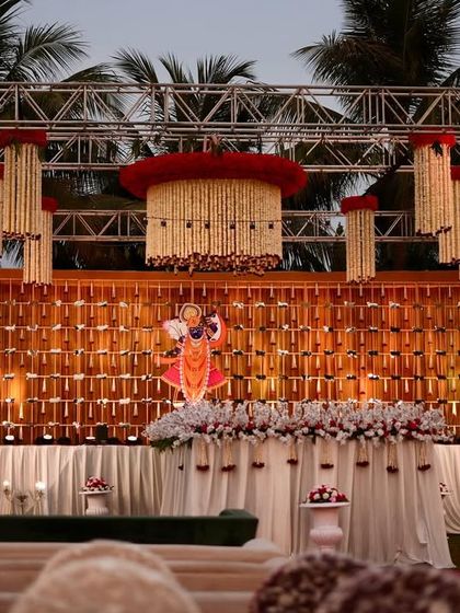 Another angle of the grand stage, showing the scale of the floral chandeliers and the detailed backdrop. This is a perfect example of our expertise in traditional and grand Indian wedding decor.