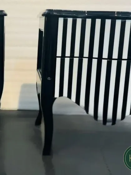 A pair of the black-and-white striped chests, showing their dramatic and eye-catching design. We craft experiences of luxury, comfort, and elegance.