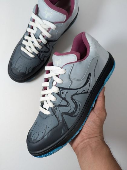 Holding up the Venom custom. The colorway is based on an old pair of Venom-themed Vans I loved, but with my own spin.