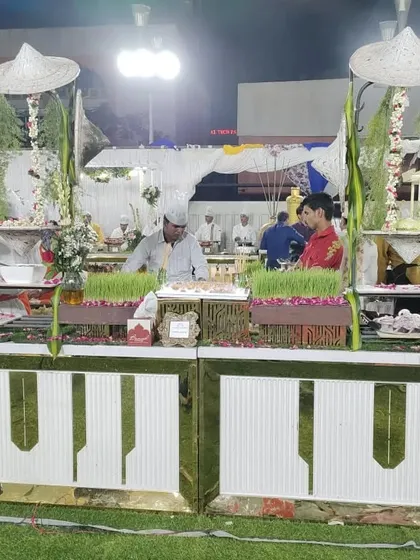 A farm-themed salad buffet counter with wheatgrass planters and traditional Indian farmer hats, showcasing my creative approach to event catering.