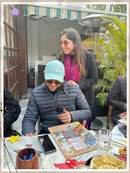 I love guiding participants through their creative process. Here, I'm sharing a moment with someone, discussing the images and words he chose for his board. It's a collaborative journey of self-discovery.