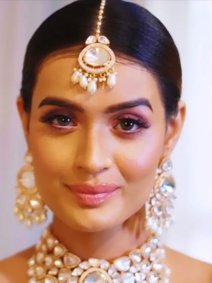 A stunning pink glam eye look for a bride. This style is perfect for pre-wedding functions, adding a touch of modern color while maintaining bridal elegance.