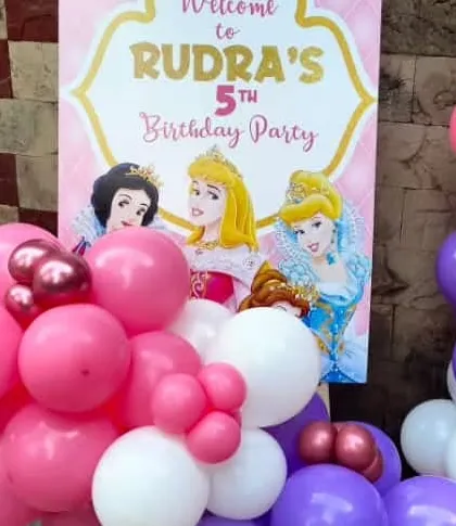 A close-up of the welcome sign for a princess themed party, featuring classic Disney princesses. This custom sign adds a personal touch to the event entrance.