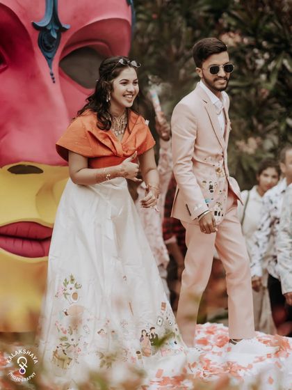 The couple dancing and enjoying themselves on stage at their colorful carnival party.