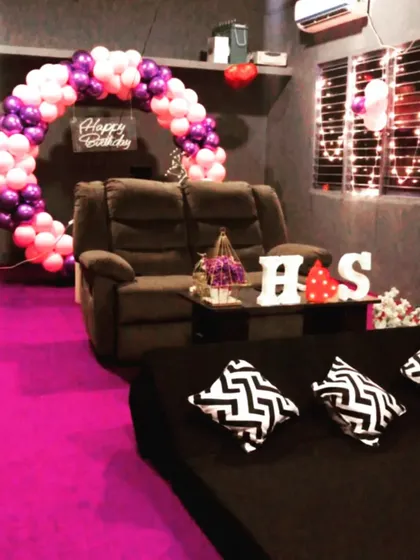 Another angle of our popular pink and purple birthday decor. You can see the cozy seating arrangement with floor cushions, perfect for a relaxed movie night celebration with friends.