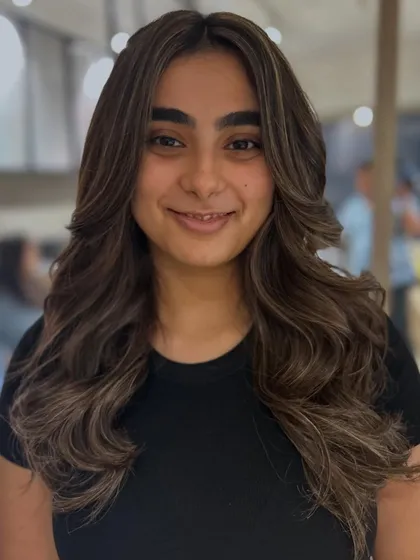 The client's happy face says it all. This cool-tone highlight blend brightens her look and complements her features perfectly.