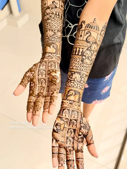 A stunning engagement mehendi with full coverage. This design is filled with traditional elements like swans, peacocks, elephants, and architectural domes.