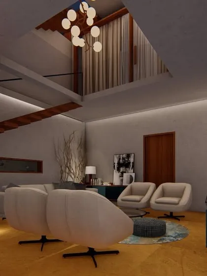 A family living area with a double-height ceiling and exposed brick wall. We used comfortable, modern furniture and a unique chandelier to create a space that feels both grand and relaxed.
