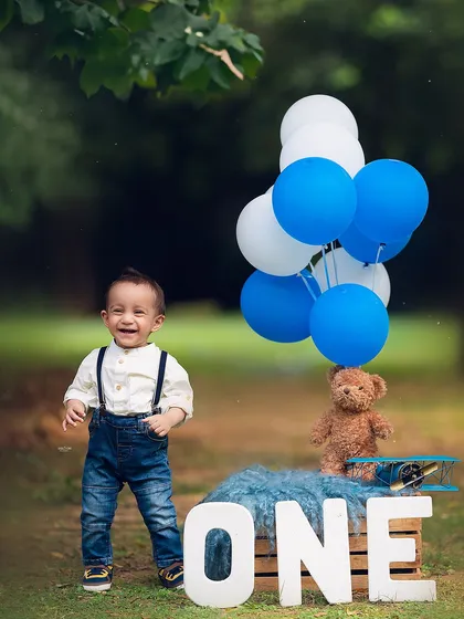 A big, happy smile from the birthday boy during his outdoor first birthday session.