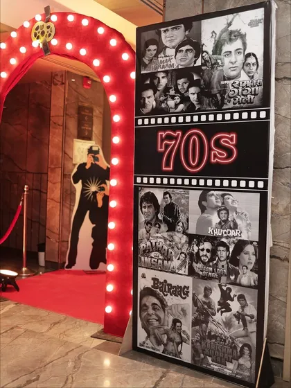 Details matter. This custom-designed panel showcasing iconic 70s films was a key part of the entrance decor, sparking nostalgia and conversation among guests as they arrived for the retro-themed celebration.