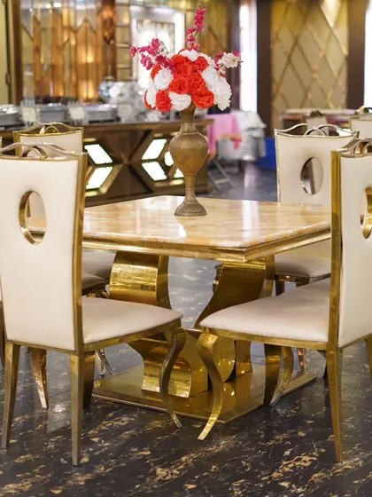 Elegant table setup at the wedding venue, with gold and cream chairs that add a touch of class.