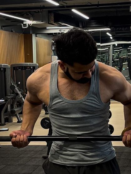 A moment of focus and intensity during a bicep curl. This is the dedication that builds muscle.