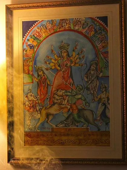 A framed Durga painting, bringing a divine and festive atmosphere into the home during the pujo season. The details and colors are inspired by traditional depictions of the goddess.