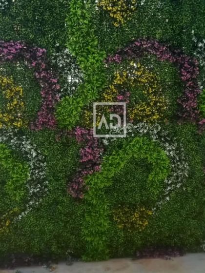 A full view of the custom-patterned flowering vertical garden. This shows how a large wall can be turned into a piece of floral art, suitable for event spaces or feature walls in cafes.