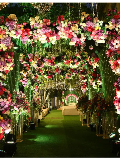 A floral archway that leads into a garden of lights. This entrance for a comedy night shows that even fun events can have a beautiful and lush welcome.