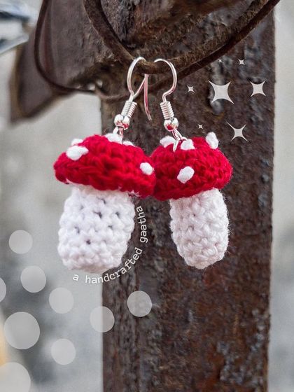 A whimsical shot of the mushroom earrings hanging outdoors. They look like they've been plucked right from a fairytale forest.