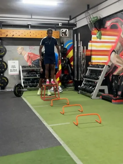 A depth jump in progress. This advanced plyometric drill trains the body to absorb and redirect force quickly, a key component of reactive strength.