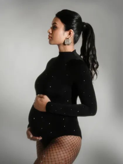 A profile shot of a mother-to-be, demonstrating how to use light to sculpt and define the beautiful curves of pregnancy.