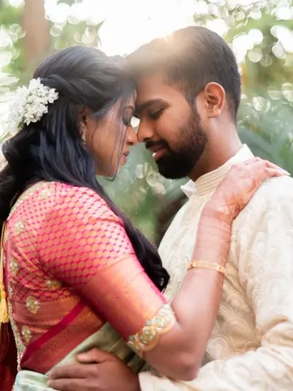 A tender moment between the couple, framed by lush greenery and beautiful backlighting. This is a perfect example of a romantic, natural light portrait.