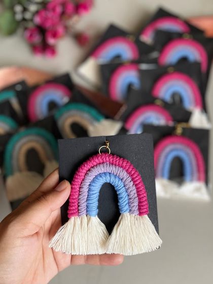 Holding a packaged rainbow keychain, ready to be gifted.