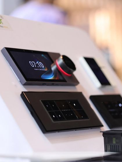 A close-up of a sleek, modern smart home control panel with an illuminated dial, showcasing the high-end design and user interface of products at the expo.