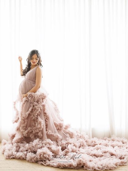 This soft mauve gown with a cloud of ruffles at the bottom creates a dreamy, romantic look against the bright, airy backdrop.