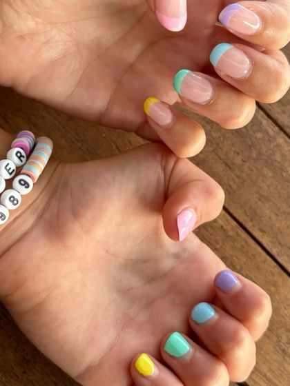Fun pastel rainbow French tips, perfect for summer or a Taylor Swift concert.